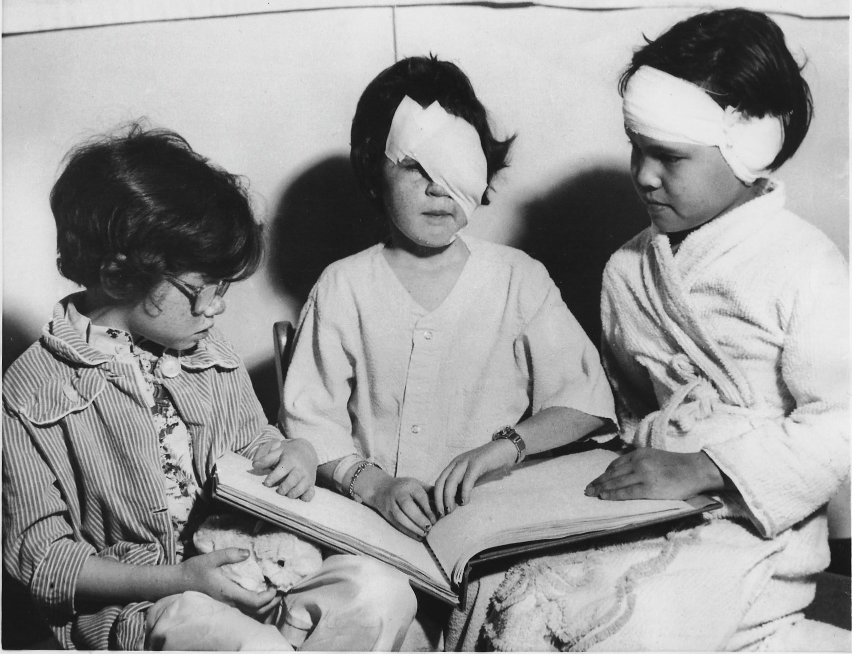 The Boston Globe featured seven-year-old Judy reading a braille book to fellow patients at Boston's Eye and Ear Hospital.