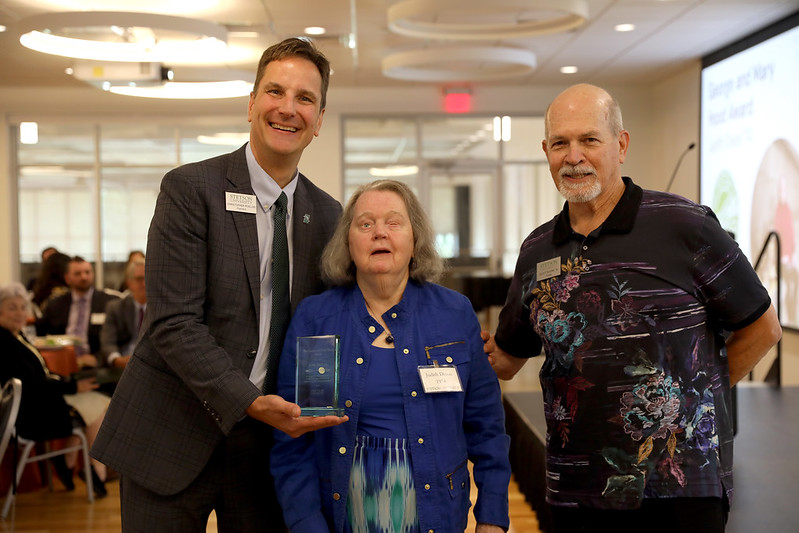 Photo of Judy receiving award from university president.